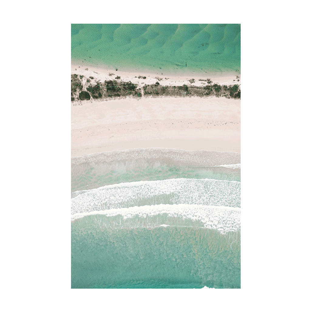 Aerial view of Broulee Beach on the South Coast of NSW, showcasing turquoise waters, soft white sand, and gentle rolling waves in a minimalist coastal composition.