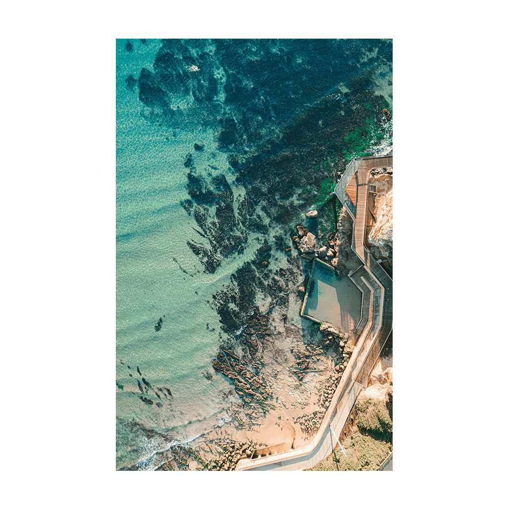 Aerial view of Terrigal’s rock pool and boardwalk, surrounded by clear turquoise waters and rocky outcrops along the Central Coast, NSW.