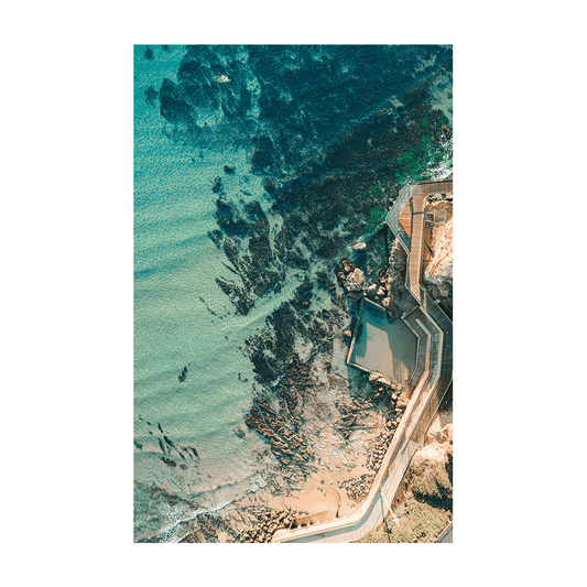 Aerial view of Terrigal’s rock pool and boardwalk, surrounded by clear turquoise waters and rocky outcrops along the Central Coast, NSW.