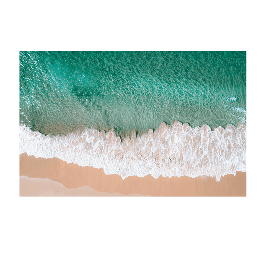 Aerial view of waves rolling onto the golden sand at Bateau Bay, NSW, creating a striking contrast between turquoise water and foamy white surf.