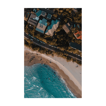 A stunning aerial print of Byron Bay, NSW, showcasing colourful beach houses, palm trees, and golden sandy shores at sunset. A perfect coastal scene.