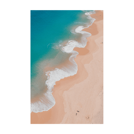 Aerial view of Copacabana Beach, NSW, featuring deep blue and turquoise waters twirling onto golden sands with people scattered along the shoreline.
