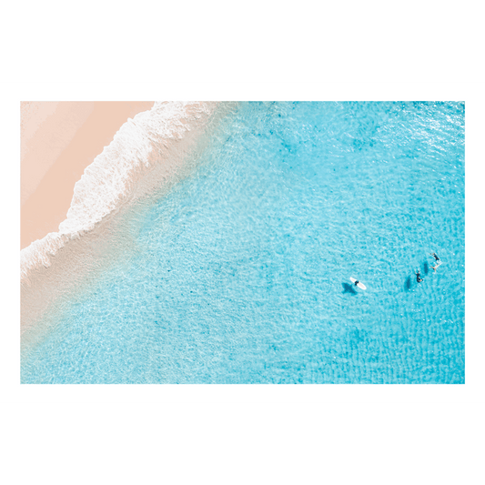 A stunning aerial beach print of Forresters Beach, NSW, featuring pastel sands, clear blue waters, and surfers floating in the shallows.