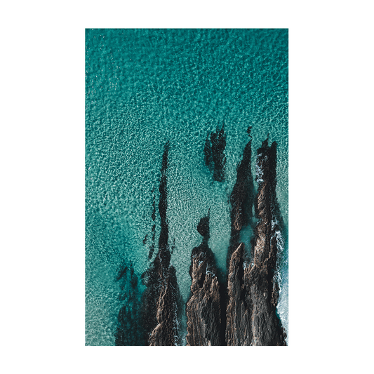 A stunning aerial coastal print of Forster, NSW, showcasing jagged rock formations emerging through clear turquoise waters.