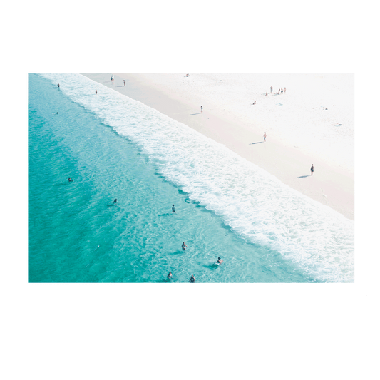 Hyams Beach aerial print showcasing crystal-clear turquoise waters meeting pristine white sand, with beachgoers enjoying the gentle waves along the South Coast of NSW. Coastal wall art capturing Australia's iconic seaside beauty.