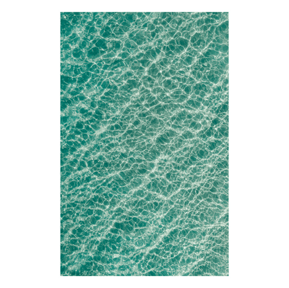 Aerial view of crystal-clear waters at Soldiers Beach, NSW, showcasing mesmerising light reflections and intricate ocean patterns.