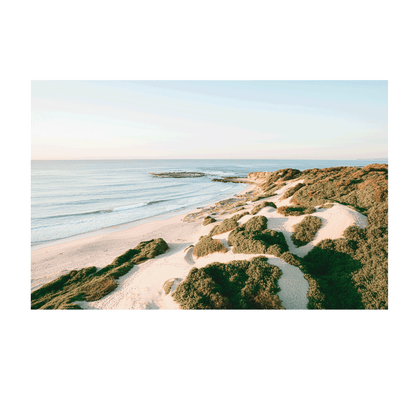 A breathtaking aerial view of Soldiers Beach, Norah Head, NSW, highlighting golden sand dunes rolling towards the tranquil ocean.