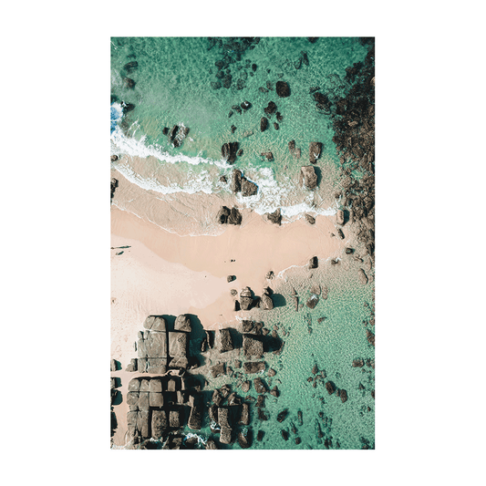 A breathtaking aerial view of Soldiers Beach, Norah Head, NSW, showcasing geometric rock formations, soft sand, and crystal-clear turquoise waters.
