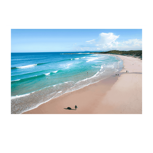 A stunning aerial view of Soldiers Beach, Norah Head, NSW, featuring rolling waves, golden sand, and beachgoers enjoying a sunny day by the sea.
