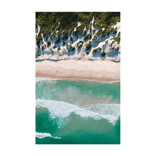 A stunning aerial view of Soldiers Beach, Norah Head, NSW, featuring rolling green dunes, soft white sand, and turquoise ocean waves.