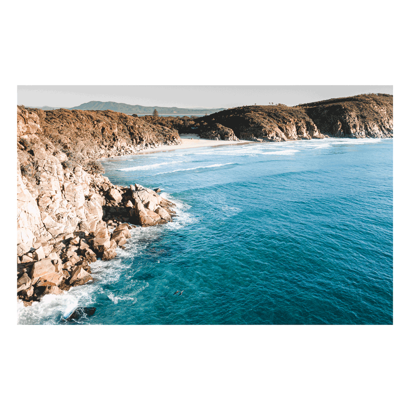 A stunning aerial print of South West Rocks, NSW, showcasing the rugged cliffs and deep blue waters of Little Bay.