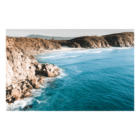 A stunning aerial print of South West Rocks, NSW, showcasing the rugged cliffs and deep blue waters of Little Bay.