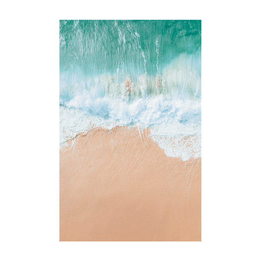 An aerial view of Spoon Bay, Central Coast, capturing powerful turquoise waves crashing onto soft golden sands in a perfect land-sea balance.