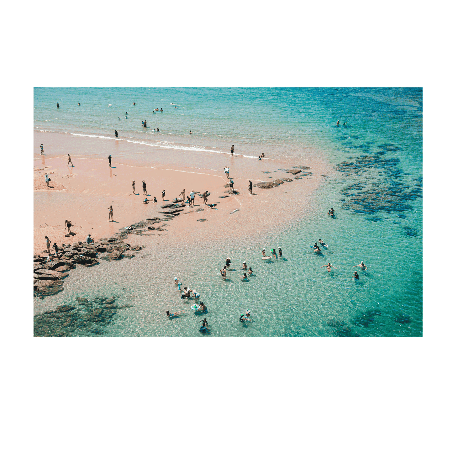 Aerial view of Toowoon Bay Beach showcasing families and beachgoers enjoying the crystal-clear waters and soft golden sand. A vibrant coastal scene capturing the essence of summer and outdoor fun.
