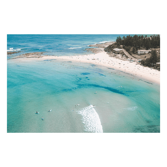 Aerial view of Toowoon Bay Beach, showcasing golden sands, turquoise waters, and beachgoers enjoying the sun. The stunning coastal landscape highlights the natural beauty of the shoreline, making it a perfect addition to any beach-inspired space.
