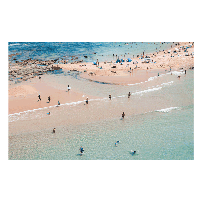 Aerial view of Toowoon Bay Beach on the Central Coast, capturing beachgoers enjoying the shoreline with blue tents scattered across the sand. A vibrant coastal print reflecting the essence of a late summer day.
