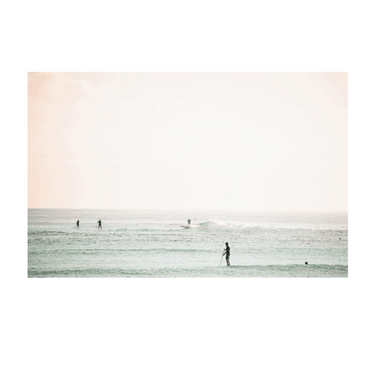 A serene coastal scene of Toowoon Bay Beach, featuring paddleboarders and surfers gliding across pastel-hued waters. A soft, minimalist ocean print perfect for adding a calming beachside aesthetic to any space.
