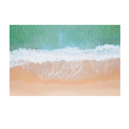 An aerial view of Wamberal Beach, NSW, showcasing waves washing onto golden sand with soft aqua and turquoise ocean tones.
