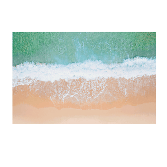 An aerial view of Wamberal Beach, NSW, showcasing waves washing onto golden sand with soft aqua and turquoise ocean tones.
