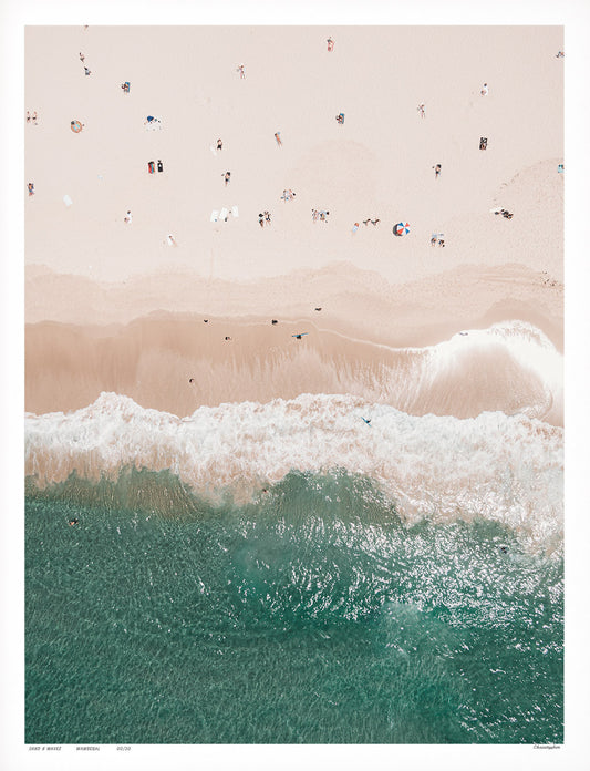 An aerial view of Wamberal Beach, NSW, showcasing golden sand, turquoise ocean waves, and sunbathers scattered along the shoreline.
