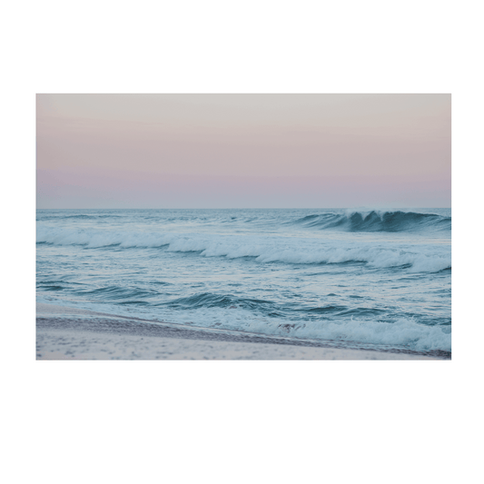 A serene pastel-hued seascape of Wamberal Beach, NSW, featuring gentle rolling waves and a soft pink and blue sky at dusk.
